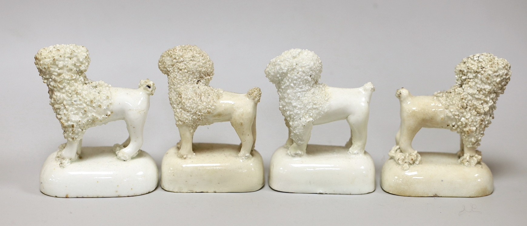 Four Staffordshire models of poodles, c.1830-50, tallest 6.5cm, Provenance: Dennis G. Rice collection